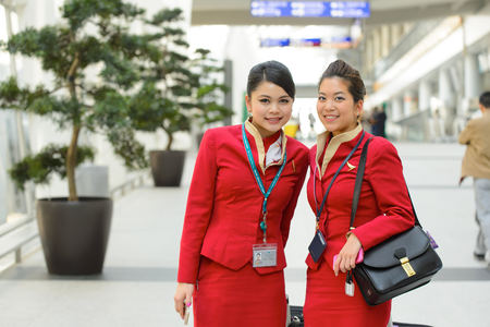 HONG KONG - APRIL 15, 2015: Cathay Pacific crew members posing in airport. Cathay Pacific is the flag carrier of Hong Kong, with its head office and main hub located at Hong Kong International Airport.のeditorial素材