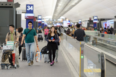 HONG KONG - MARCH 09, 2015: Hong Kong International Airport interior. It is the main airport in Hong Kong. It is located on the island of Chek Lap Kok, which largely comprises land reclaimed for the construction of the airport itself.のeditorial素材