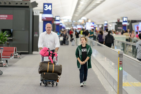 HONG KONG - MARCH 09, 2015: Hong Kong International Airport interior. It is the main airport in Hong Kong. It is located on the island of Chek Lap Kok, which largely comprises land reclaimed for the construction of the airport itself.のeditorial素材