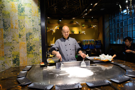SHENZHEN, CHINA - FEBRUARY 04, 2015: cooking master in asian restaurant. ShenZhen is regarded as one of the most successful Special Economic Zones.のeditorial素材