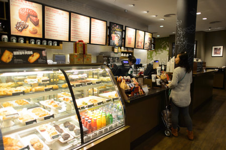 SHENZHEN, CHINA - FEBRUARY 16, 2015: Starbucks Cafe interior. Starbucks Corporation is an American global coffee company and coffeehouse chain based in Seattle, Washingtonのeditorial素材