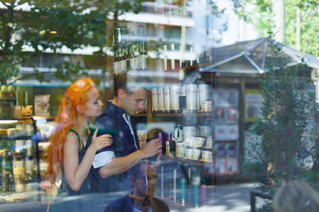 PARIS - SEP 09: young couple dating in Parisian Sturbucks cafe on September 09, 2014. Paris, aka...