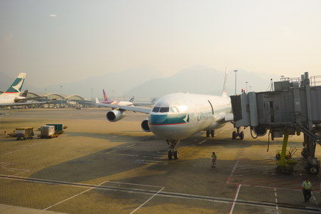 HONG KONG - OCT 17: Cathay Pacific aircraft near boarding bridge in airport on October 17, 2014 in...