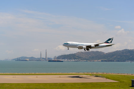 HONG KONG - JUNE 04, 2015: Cathay Pacific aircraft landing. Cathay Pacific is the flag carrier airline of Hong Kong, with its head office and main hub located at Hong Kong International Airportのeditorial素材