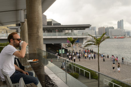 HONG KONG - MAY 06, 2015: Starbucks customer drink coffee. Starbucks is the largest coffeehouse...