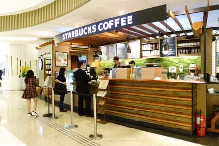 HONG KONG - APRIL 16, 2015: Starbucks Cafe in shopping mall. Starbucks Corporation is an American global coffee company and coffeehouse chain based in Seattle, Washingtonのeditorial素材