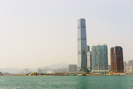 HONG KONG - APRIL 16, 2015: Victoria harbor with Hong Kong skyline in the background. Victoria Harbour is a natural landform harbour situated between Hong Kong Island and Kowloon in Hong Kong.のeditorial素材