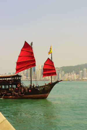 HONG KONG - APRIL 16, 2015: sailboat across Victoria Harbour. Victoria Harbour is a natural landform...