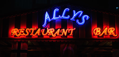 Neon shining signboard at nightの写真素材