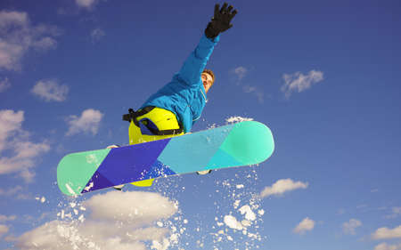 young man take fun on the snowboardの写真素材