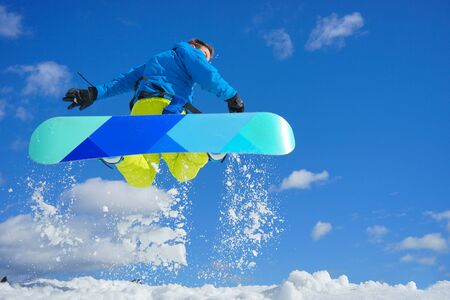young man take fun on the snowboardの写真素材