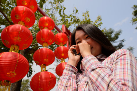 Chinese woman talking on cell phone during chinese new year