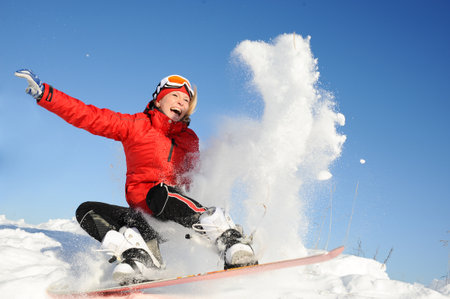 Young woman take fun on the snowboardの写真素材