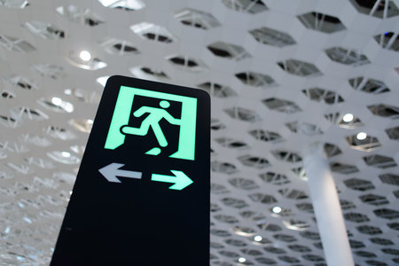 SHENZHEN - APRIL 16: exit sign in airport on April 16, 2014 in Shenzhen, China. Shenzhen Bao'an International Airport is located near Huangtian and Fuyong villages in Bao'an District, Shenzhen, Guangdongのeditorial素材
