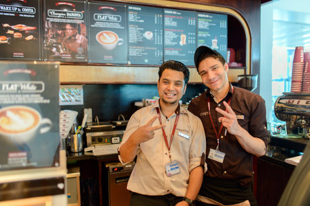DUBAI, UAE - APRIL 18: Costa Coffee barmen posing on April 18, 2014 in Dubai. Costa Coffee is a British multinational coffeehouse company headquartered in Dunstable, United Kingdom.のeditorial素材