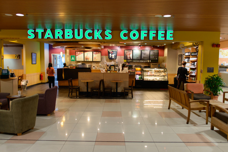 KUCHING - MAY 02: airport cafe interior on May 02, 2014 in Kuching, Malaysia. Starbucks is the largest coffeehouse company in the world, with 23,187 stores in 64 countriesのeditorial素材