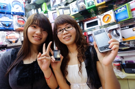 SHENZHEN, CHINA-APRIL 02: young sellers in cellphone store on April 02, 2010 in Shenzhen, China. ShenZhen is regarded as one of the most successful Special Economic Zones.のeditorial素材