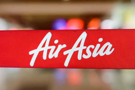 KUCHING - MAY 06: red tape with Airasia inscription on May 06, 2014 in Kuching, Malaysia. AirAsia Berhad is a Malaysian low-cost airline headquartered in Kuala Lumpur, Malaysiaのeditorial素材