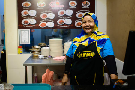 LANGKAWI - MAY 04: cook in Malaysian snack bar on May 04, 2014 in Langkawi, Malaysia. Malaysia's cuisine reflects the multi-ethnic makeup of its populationのeditorial素材