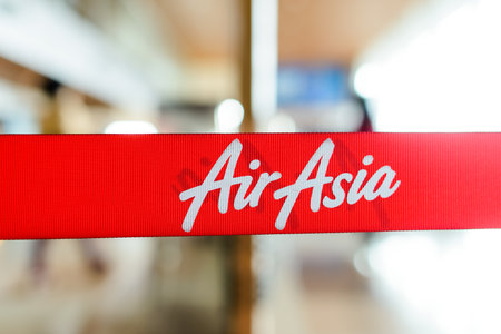 KUCHING - MAY 06: red tape with Airasia inscription on May 06, 2014 in Kuching, Malaysia. AirAsia Berhad is a Malaysian low-cost airline headquartered in Kuala Lumpur, Malaysiaのeditorial素材