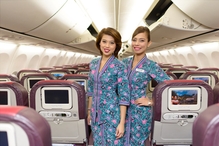 HONG KONG, CHINA - MAY 12, 2014: Malaysian Airline crew members posing in Boeing 737 aircraft after landing on MAY 12, 2014. Malaysian Airline System is the flag carrier airline of Malaysiaのeditorial素材