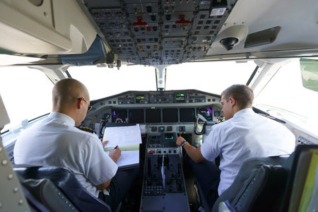 GENEVA - SEPTEMBER 16: Etihad Regional pilots in aircraft cockpit on September 16, 2014 in Geneva, Switzerland. Darwin Airline, operating under the brand name Etihad Regional since January 2014のeditorial素材
