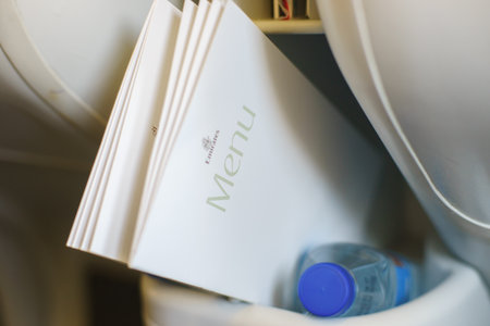 DUBAI, UAE - FEBRUARY 14: close-up shot of menu in Emirates Airbus A340 business class on February 14, 2013 in Dubai, UAE. Emirates handles major part of passenger traffic and aircraft movements at the airport.のeditorial素材