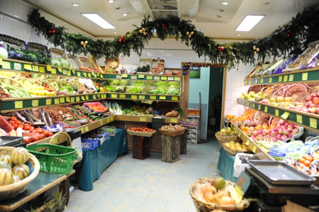 PARIS, FRANCE - DECEMBER 09: French vegetable shop in Paris with a lot of fruits and vegeteble on December 09, 2008 in Paris, Franceのeditorial素材