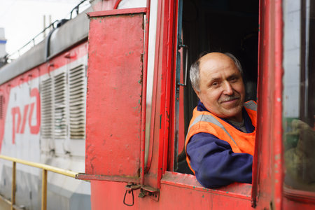 MOSCOW - MAY 23: locomotive driver on May 23, 2013 in Moscow, Russia. JSC Russian Railways in 2012 became one of the three largest transport companies in the worldのeditorial素材