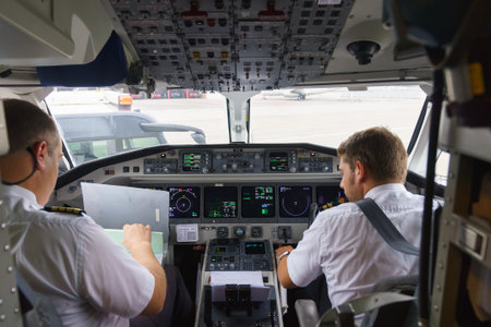GENEVA - SEPTEMBER 11: Etihad Regional pilots in aircraft cockpit on September 11, 2014 in Geneva, Switzerland. Darwin Airline, operating under the brand name Etihad Regional since January 2014のeditorial素材