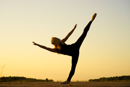 Professional gymnast woman dancer in black clothingの写真素材
