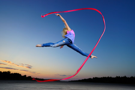 Professional gymnast woman at nightの写真素材