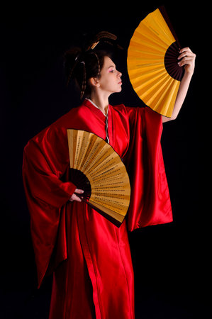 The girl in native costume of japanese geisha, isolated on blackのeditorial素材