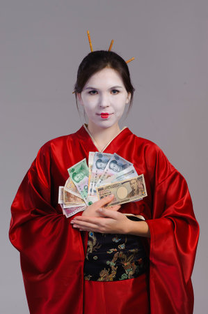 The girl in native costume of japanese geisha, isolated on greyの写真素材