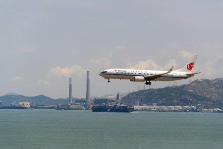 HONG KONG - JUNE 04, 2015: Air China aircraft landing at Hong Kong airport. Air China Limited is the flag carrier and one of the major airlines of the People's Republic of China, with its headquarters in Shunyi District, Beijing.のeditorial素材