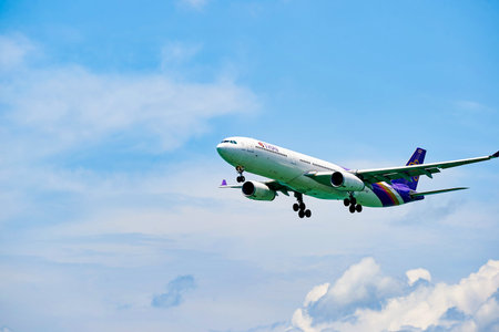 HONG KONG - JUNE 04, 2015: THAI aircraft landing at Hong Kong airport. Thai Airways International...