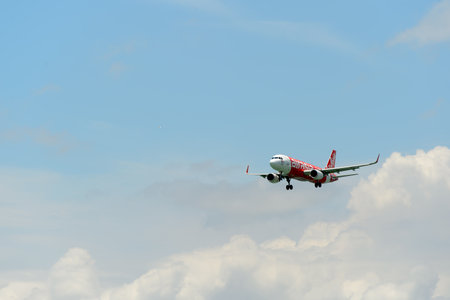 HONG KONG - JUNE 04, 2015: Air Asia aircraft landing at Hong Kong airport. AirAsia Berhad is a...