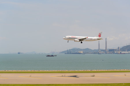 HONG KONG - JUNE 04, 2015: Dragonair aircraft landing at Hong Kong airport. Dragonair is a Hong Kong-based international regional airlineのeditorial素材