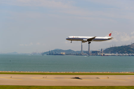 HONG KONG - JUNE 04, 2015: Air China aircraft landing at Hong Kong airport. Air China Limited is the flag carrier and one of the major airlines of the People's Republic of China, with its headquarters in Shunyi District, Beijing.のeditorial素材