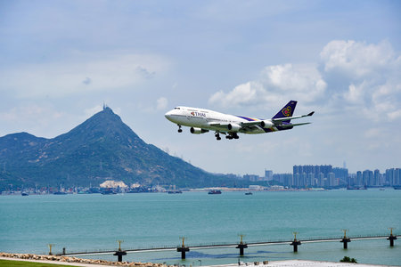 HONG KONG - JUNE 04, 2015: THAI aircraft landing at Hong Kong airport. Thai Airways International Public Company Limited, also trading as THAI is the flag carrier airline of Thailandのeditorial素材
