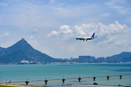 HONG KONG - JUNE 04, 2015: XiamenAir aircraft landing at Hong Kong airport. XiamenAir (formerly Xiamen Airlines) is the first privately owned airline in the People's Republic of Chinaのeditorial素材