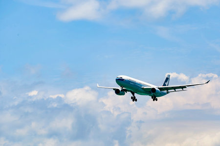 HONG KONG - JUNE 04, 2015: Cathay Pacific aircraft landing at Hong Kong airport. Cathay Pacific is...