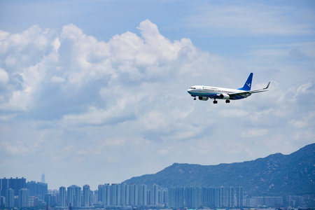 HONG KONG - JUNE 04, 2015: XiamenAir aircraft landing at Hong Kong airport. XiamenAir (formerly Xiamen Airlines) is the first privately owned airline in the People's Republic of Chinaのeditorial素材