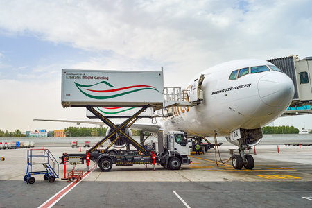 DUBAI, UAE - JUNE 23, 2015: Boeing 777-300ER docked in Dubai airport. Dubai International Airport is an international airport serving Dubai. It is a major airline hub in the Middle East, and is the main airport of Dubai.のeditorial素材
