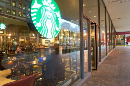 CHICAGO, IL - CIRCA MARCH, 2016: people in Starbucks Cafe. Starbucks Corporation is an American global coffee company and coffeehouse chain based in Seattle, Washingtonのeditorial素材