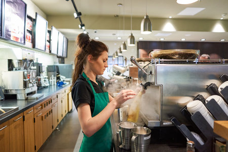 SAINT PETERSBURG, RUSSIA - MARCH 12, 2016: worker at Starbucks Cafe. Starbucks Corporation is an American global coffee company and coffeehouse chain based in Seattle, Washingtonのeditorial素材