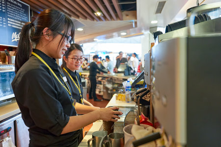 HONG KONG - MARCH 08, 2016: worker at McCafe in the Airport. McCafe is a coffee-house-style food and...