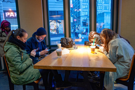 NEW YORK - CIRCA MARCH 2016: people in Starbucks Cafe. Starbucks Corporation is an American global coffee company and coffeehouse chain based in Seattle, Washingtonのeditorial素材