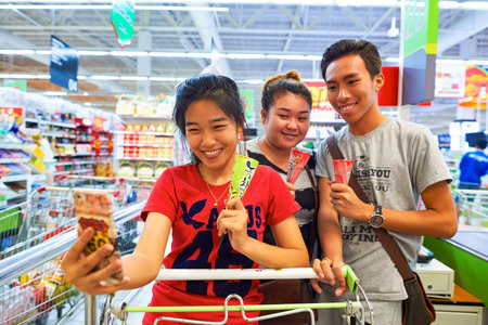 PATTAYA, THAILAND - CIRCA FEBRUARY, 2016: women taking a selfie. A selfie is a self-portrait photograph, typically taken with a digital camera or camera phone held in the hand or supported by a selfie stick.のeditorial素材