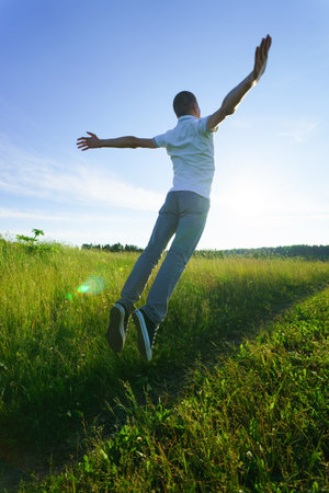 Young man take off from the landの写真素材